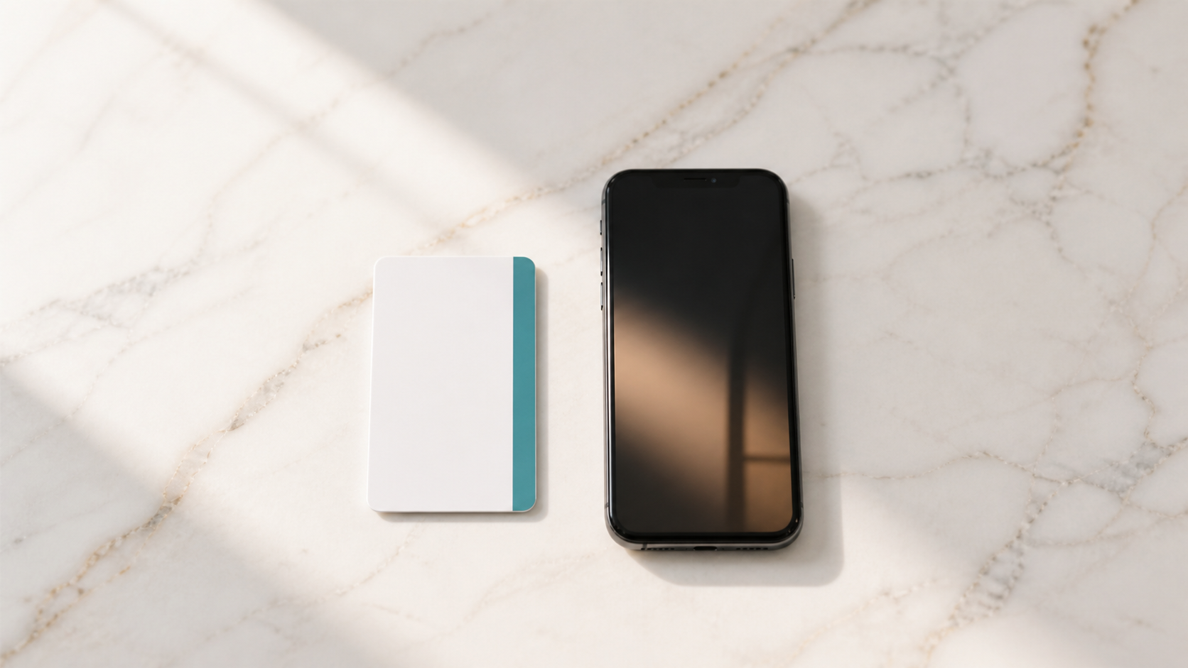 Hotel room key card and smartphone on a marble surface — AI managing guest communications for boutique hotels and travel agencies